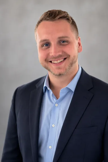 Tim Morgan, smiling, in a blue shirt and navy jacket